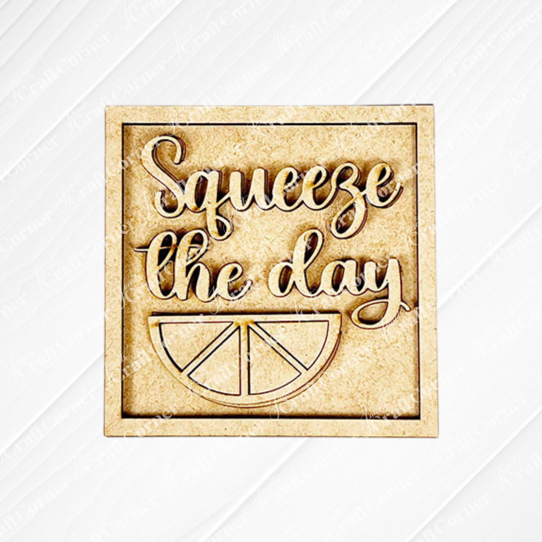 The Lemon Squares by Janet's Craft Corner features "Squeeze the day" in cursive above a lemon slice for cheerful seasonal decor. Ideal for adding to your Swappable Squares craft kit display.