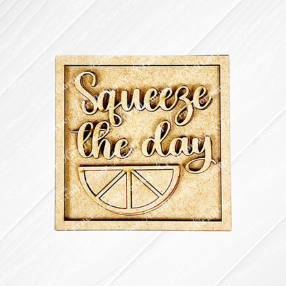 The Lemon Squares by Janet's Craft Corner features "Squeeze the day" in cursive above a lemon slice for cheerful seasonal decor. Ideal for adding to your Swappable Squares craft kit display.