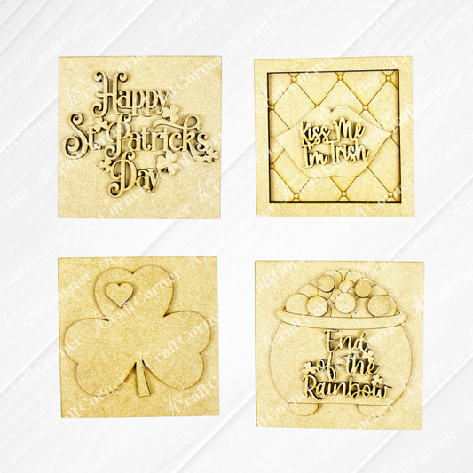 Janet's Craft Corner St Patricks Squares includes four wood cut-outs: "Happy St. Patrick’s Day" with clovers, "Kiss Me I’m Irish," a shamrock heart, and a pot of gold—ideal Swappable Squares for tiered tray decor.