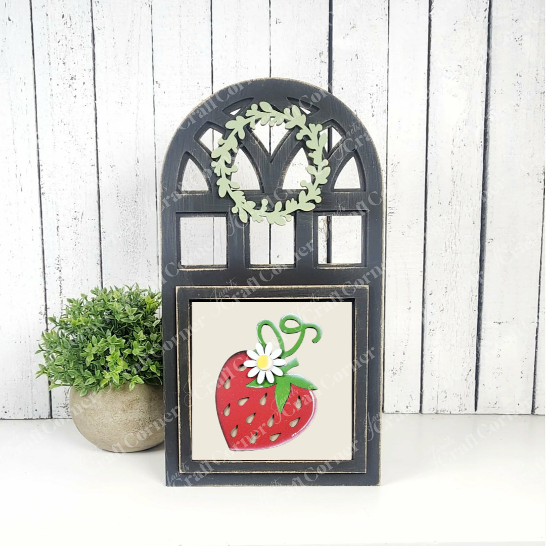 Add a touch of charm to your tiered tray with Janet's Craft Corner Strawberry Swappable Squares—a DIY kit featuring an arched black frame, green leaf wreath, strawberry and flower design—perfect for seasonal home decor.
