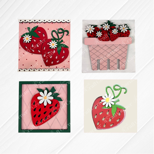 Janet's Craft Corner Strawberry Swappable Squares DIY kit features four tiered tray designs: two red strawberries with a white flower on pink, a basket of strawberries with flowers, and cute single strawberry wood cut-outs in frames.