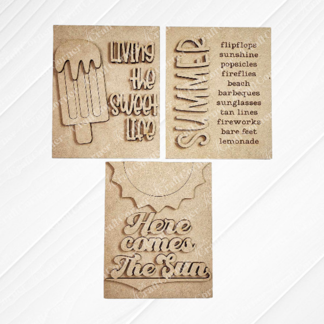 Janet's Craft Corner Summer Interchangeable Farmhouse Signs DIY kit includes three brown paper cards with laser-cut summer designs: a popsicle with "Living the Sweet Life," "SUMMER," and "Here comes The Sun"—perfect farmhouse decor.