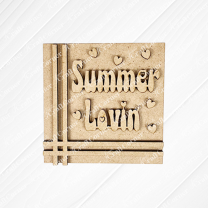 The Summer Lovin Swappable Squares DIY craft kit from Janet’s Craft Corner includes a square wooden plaque engraved with “Summer Lovin’” and heart accents—a great addition to your seasonal tiered tray or wood cut-out collection.