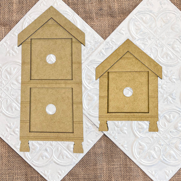 The House Swappable Squares Holders Shelf Leaner DIY Craft Kit by Janet's Craft Corner features house-shaped brown cardboard cutouts with square bodies, circular openings, and triangular roofs—perfect for farmhouse-style decor.