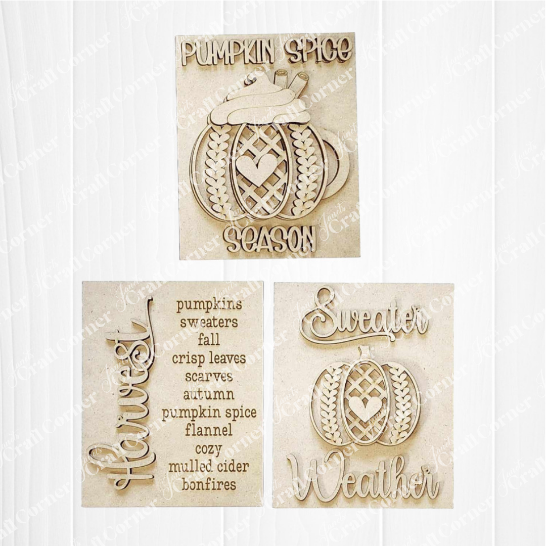 Set of three decorative signs with pumpkin spice, sweater, and weather text on a white background.