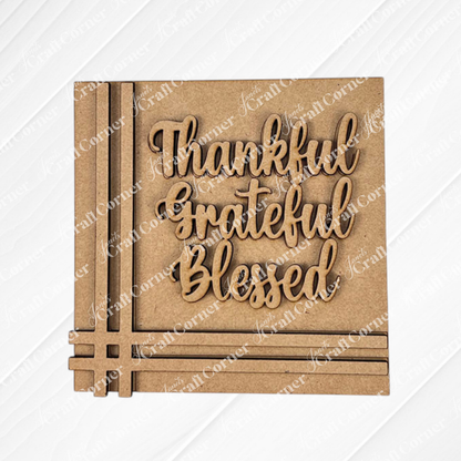 The Harvest Blessings Thanksgiving Squares by Janet's Craft Corner features “Thankful, Grateful, Blessed” in cursive wood cut-outs—ideal tiered tray decor or a charming addition to your Swappable Squares collection.