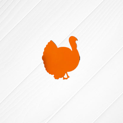 An orange turkey silhouette is centered on a white, diagonally-striped wood background in Janet's Craft Corner’s Thankful Mini Shelf Sitters—an ideal DIY seasonal decor kit for personalized decorations or your Thankful Decor Set.