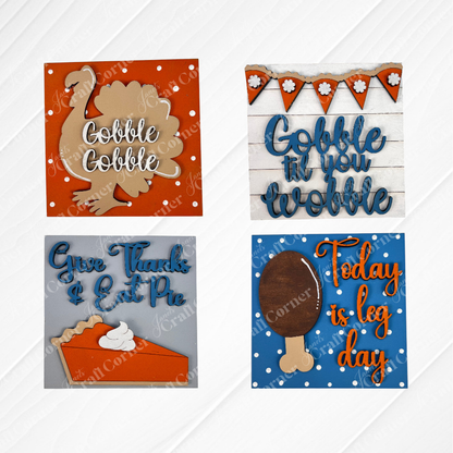 Janet's Craft Corner Thanksgiving Feast Squares feature four wood cut-outs for tiered tray decor: a turkey ("Gobble Gobble"), bunting ("Gobble til you wobble"), pie slice ("Give Thanks & Eat Pie"), and drumstick ("Today is leg day").