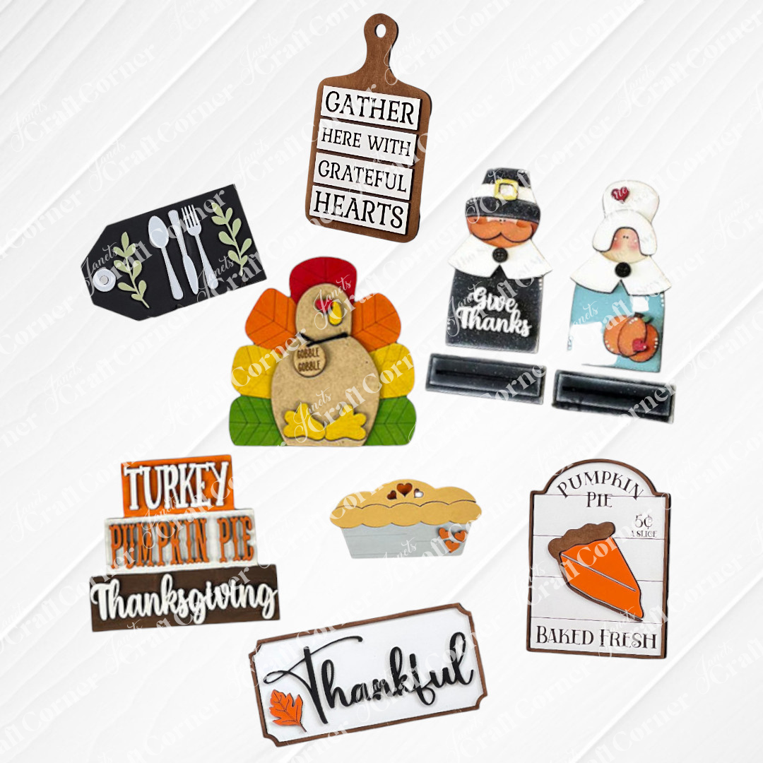 Janet's Craft Corner offers the Thanksgiving Mini Shelf Sitters DIY craft kits ideal for Thanksgiving tiered trays. It includes 8 charming wooden decorations: a turkey, pilgrim couple a word stack with words like "Turkey" and "Pumpkin Pie", breadboard with "Gather Here With Grateful Hearts" saying, a pumpkin pie baked fresh sign, a silverware tag, a pumpkin pie and a "Thanksful" sign for festive home décor.