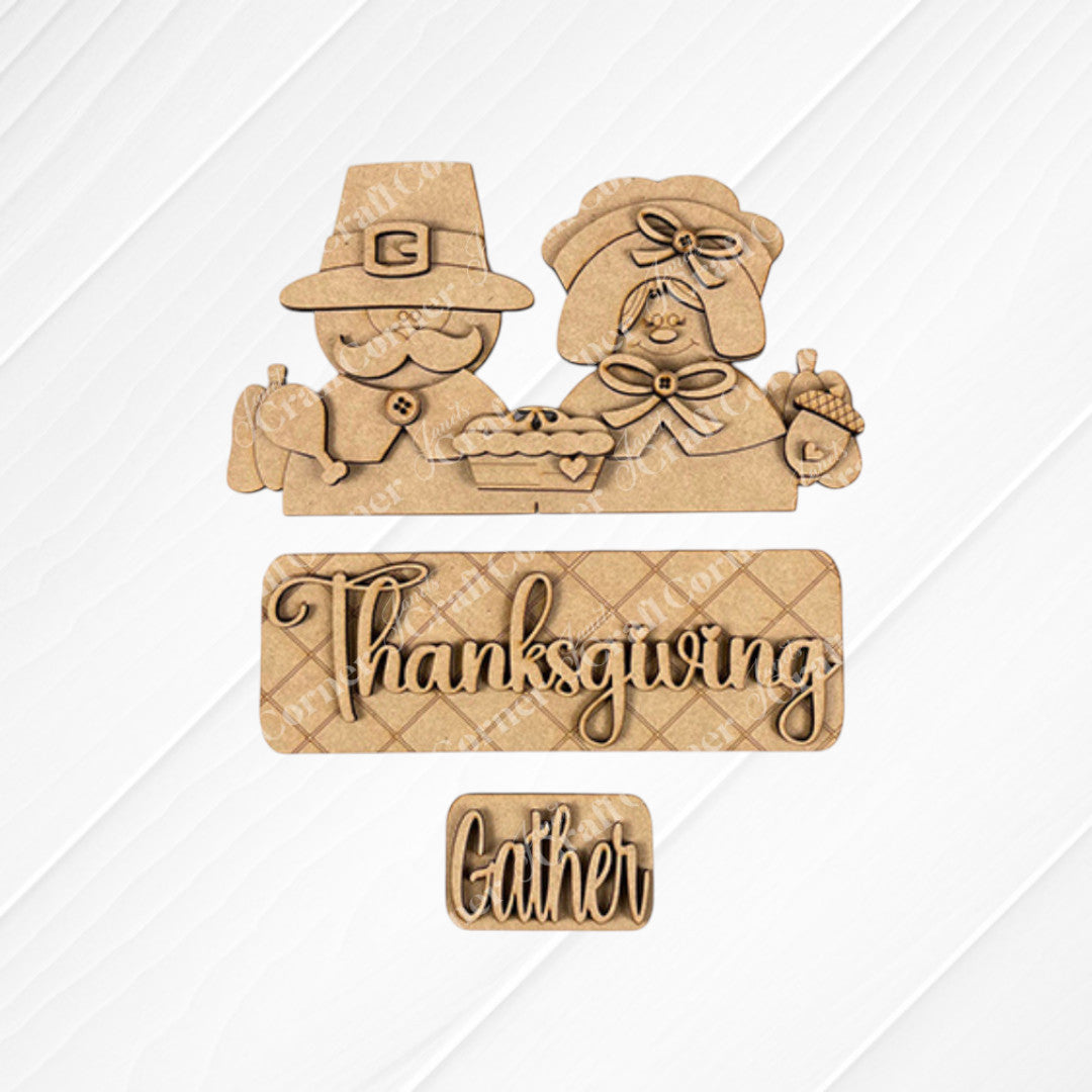 Introducing the Pilgrim Interchangeable Insert from Janet's Craft Corner: a charming decoration depicting a carved pilgrim man and woman with a pie. Beneath them, signs display "Thanksgiving" and "Gather." The textured white and burlap backdrop is ideal for use in your Thanksgiving decor or as part of your DIY home decor kit.