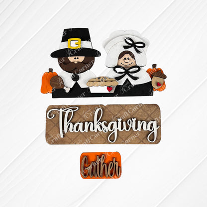 The Pilgrim Interchangeable Insert from Janet's Craft Corner is a DIY home decor kit that features a decorative design with a pilgrim couple, pumpkins, a pie, and an acorn. The word "Thanksgiving" is prominently displayed with "Gather" beneath it on a burlap-textured background, ideal for refreshing your Thanksgiving decor or creating unique craft projects.