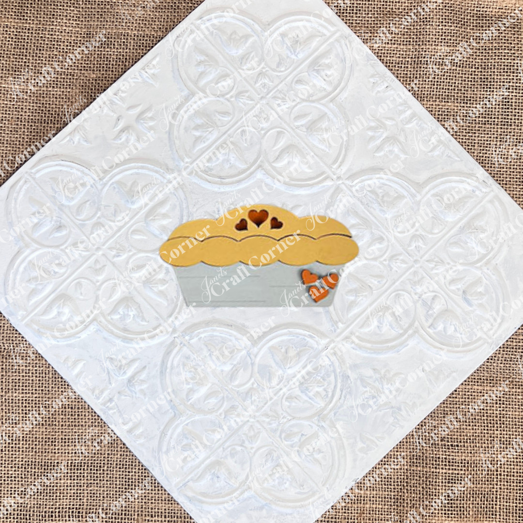 Enhance your tiered tray with the Give Thanks/Thanksgiving Tiered Tray Kit from Janet's Craft Corner, featuring charming wooden muffin-shaped pieces adorned with heart cutouts. It's a delightful addition to your home décor and sure to stand out.