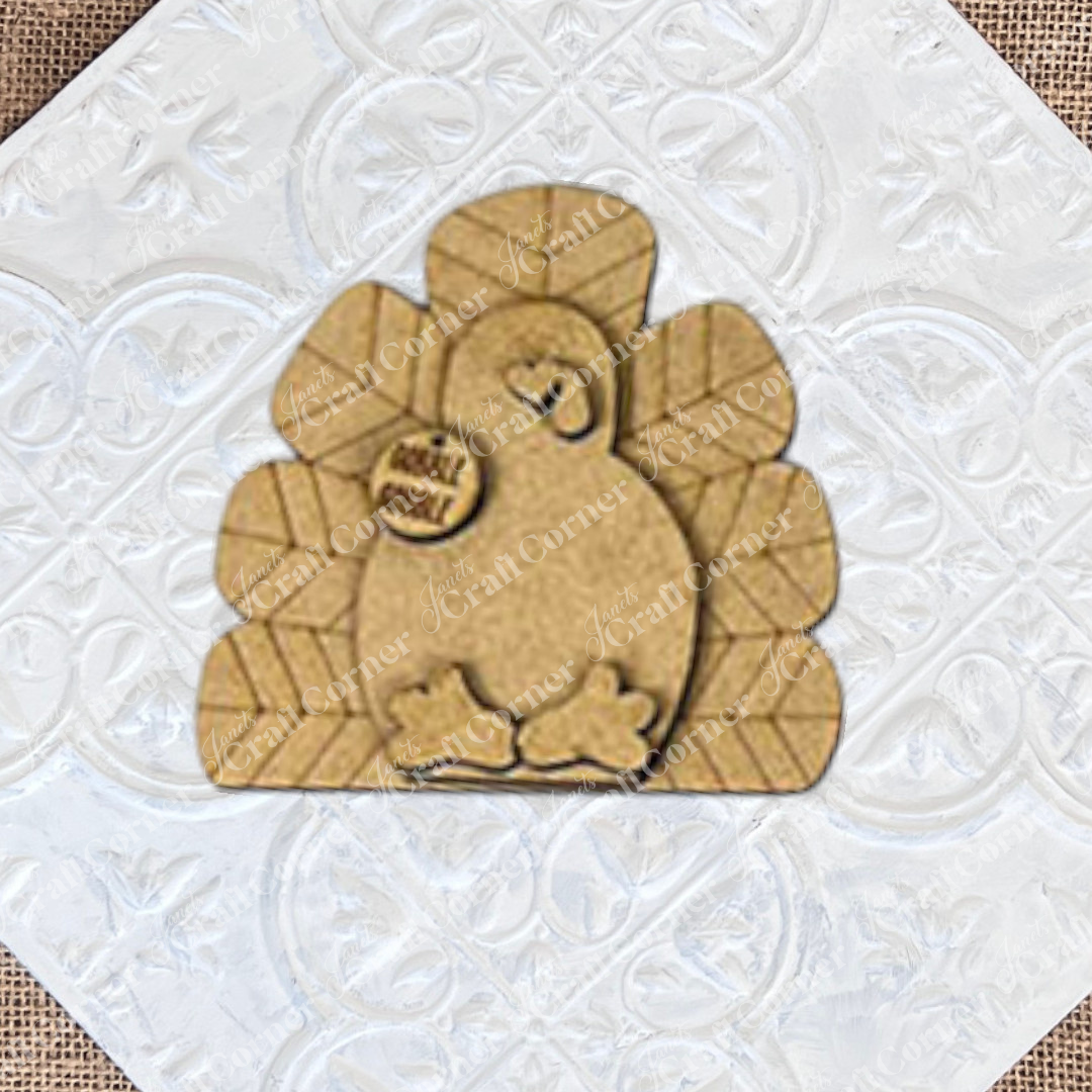 The Give Thanks/Thanksgiving Tiered Tray Kit by Janet's Craft Corner includes a DIY wooden turkey craft kit with a "gobble gobble" tag. It's perfect for enhancing your home décor and adding charm to your tiered tray setup against a simple backdrop.