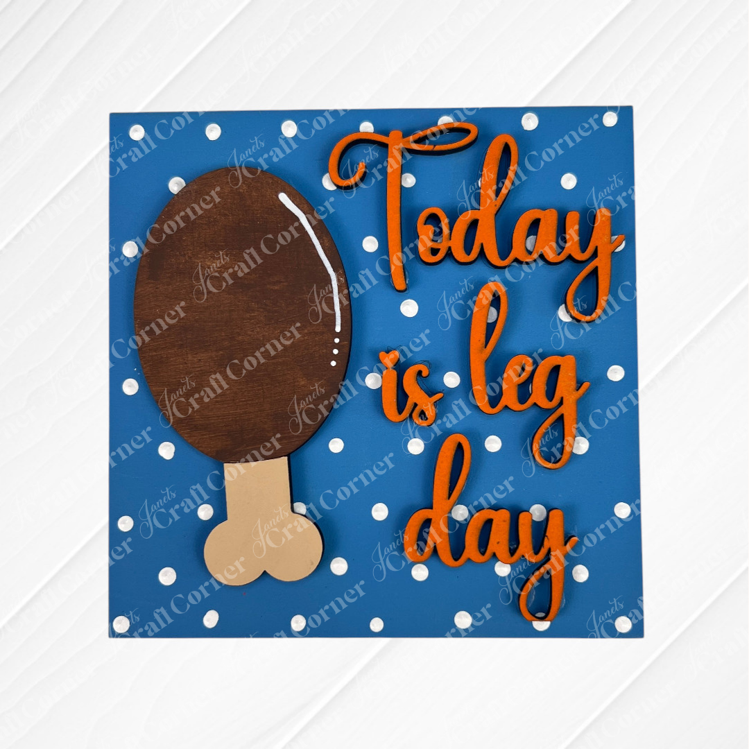 Janet's Craft Corner’s Thanksgiving Feast Squares: a sign with a brown turkey drumstick and “Today is leg day” in orange cursive on a blue polka dot background—fun tiered tray decor or display with Swappable Squares cut-outs.