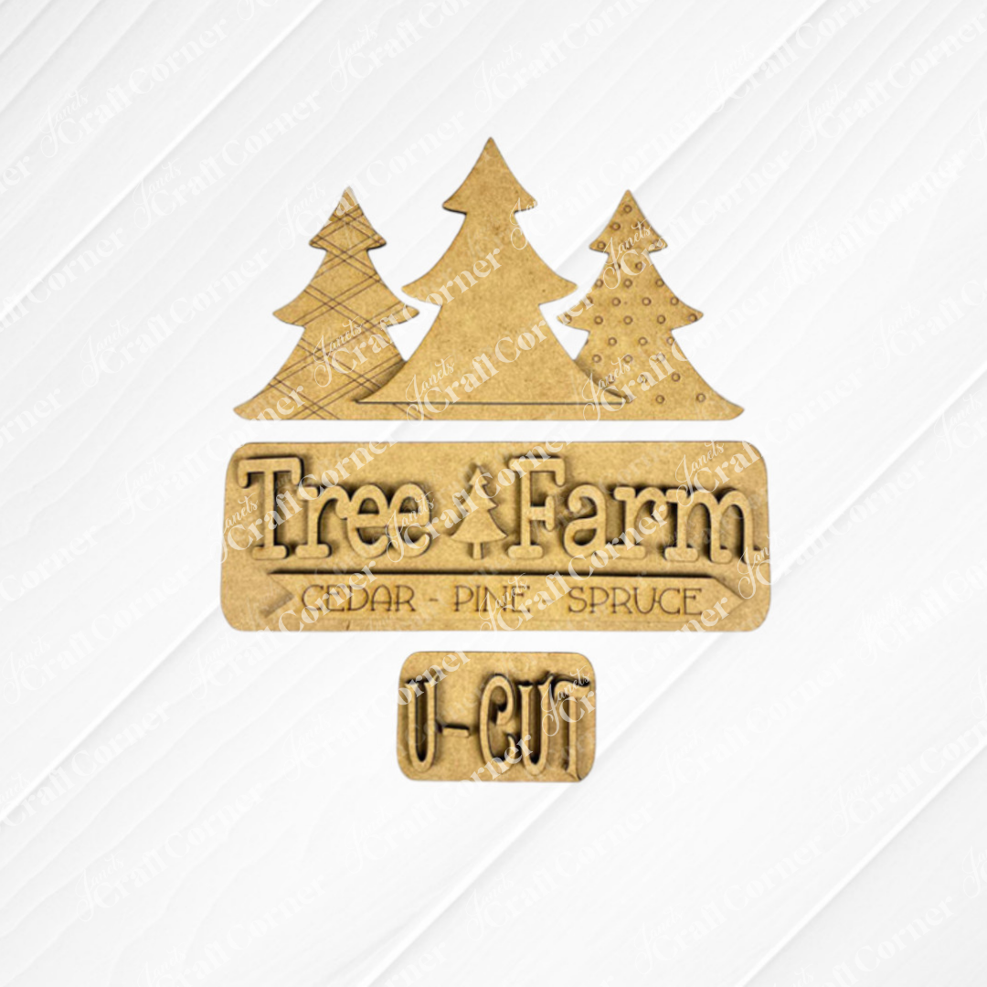 The Tree Farm Interchangeable Insert, a DIY home decor kit from Janet's Craft Corner, showcases hand-painted wooden decor with three stylized trees and text that reads "Tree Farm - Cedar - Pine - Spruce" with "U-Cut" below. The trees are lined up neatly, and the text is cut from comparable material, making it an ideal choice for holiday decorations.