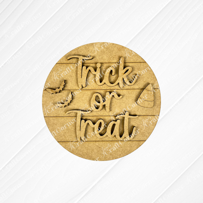 Janet's Craft Corner Halloween Mini Shelf Sitters is a DIY home decor craft kit featuring a round wooden sign with "Trick or Treat," playful font, bat and candy corn cutouts, on a light wood plank—perfect for Halloween decorations.