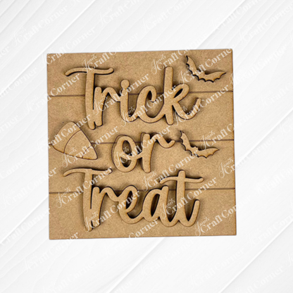 Janet's Craft Corner's Halloween Squares is a wooden sign with "Trick or Treat" in playful script and two bat shapes, perfect for tiered tray decor on a light wood background.
