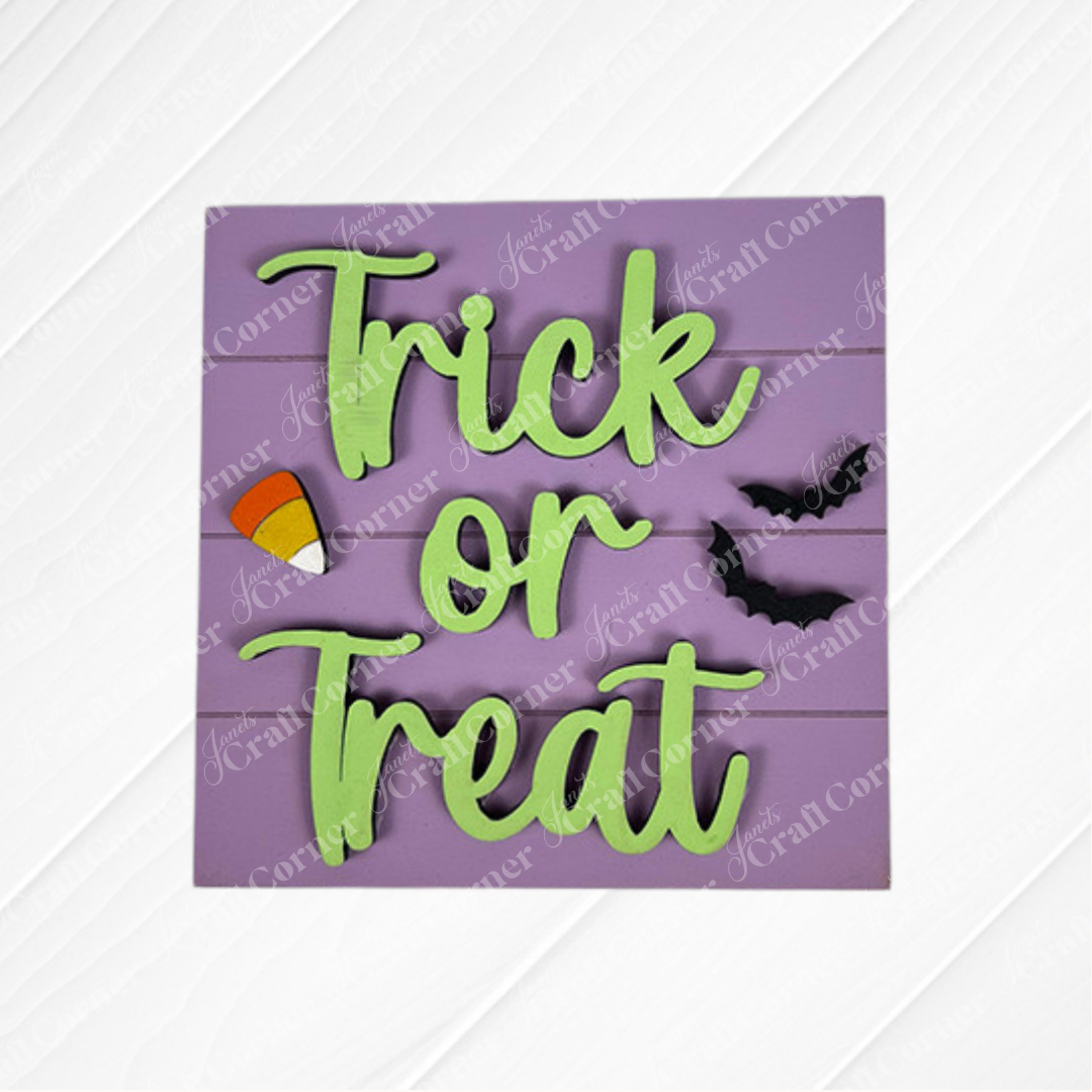The Halloween Squares from Janet's Craft Corner is a purple wood sign with green "Trick or Treat" text, candy corn, and bats—ideal for tiered trays or Swappable Squares Halloween displays.