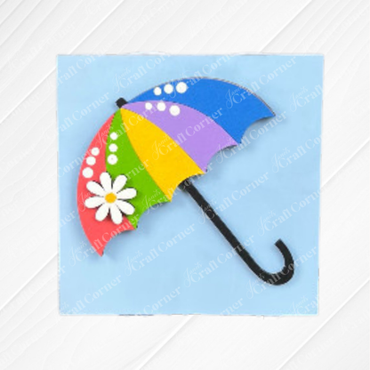 Janet's Craft Corner "Hello Spring Squares" feature a vibrant umbrella with multicolored panels, white daisy and dots on a light blue background—perfect cheerful wood cut-outs for tiered tray decor.