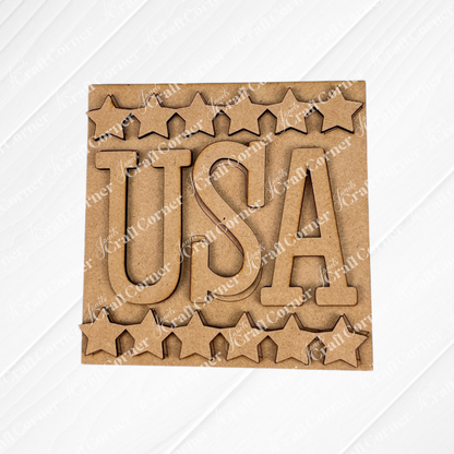 Janet's Craft Corner presents the Patriotic Squares DIY seasonal home decor kit—a square wooden cutout with bold "USA" in the center, star-shaped edges, and a plain white background, ideal for your Independence Day decorations.