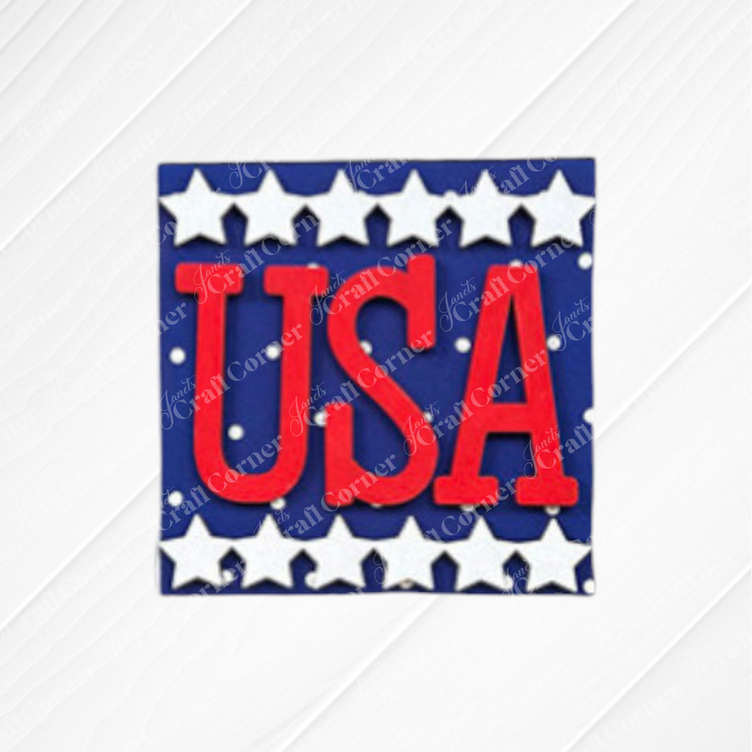 Janet's Craft Corner's "Patriotic Squares" DIY kit features a blue square sign with white stars and bold red "USA" letters—ideal for crafting your own Independence Day décor.