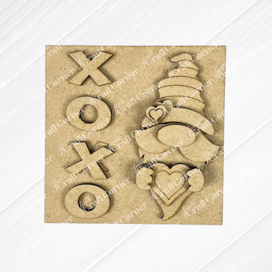 The Valentine Squares by Janet's Craft Corner is a square wooden plaque for tiered tray signs, featuring "XOXO" on the left and a gnome with a heart and tall hat with hearts on the right—perfect for festive DIY seasonal home decor kits.