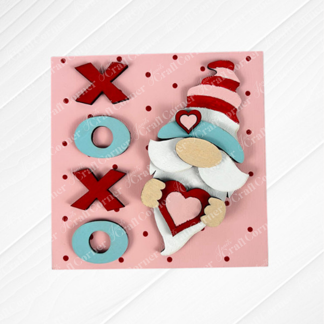 Janet’s Craft Corner’s “Valentine Squares” features a pink square card with red polka dots, a gnome holding a heart, and vertical "XOXO" in red and blue—ideal for tiered tray decor or DIY seasonal home decor.