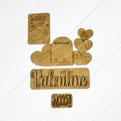 Janet's Craft Corner's Valentine Interchangeable Insert - Painted is elegantly displayed on a white background, exuding rustic charm. The inserts feature hearts with phrases such as "Be Mine" and "I ❤️ U," an envelope, and words like "Valentine" and "Smooch," providing versatile home decor options for the heartfelt occasion.