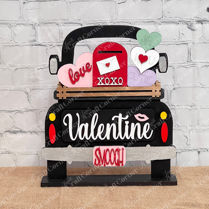 Janet's Craft Corner's DIY kit features an Antique Truck Base with heart cutouts that say "love," "xoxo," "cutie," and "be mine." This interchangeable home decor adds a rustic charm to a white brick wall.