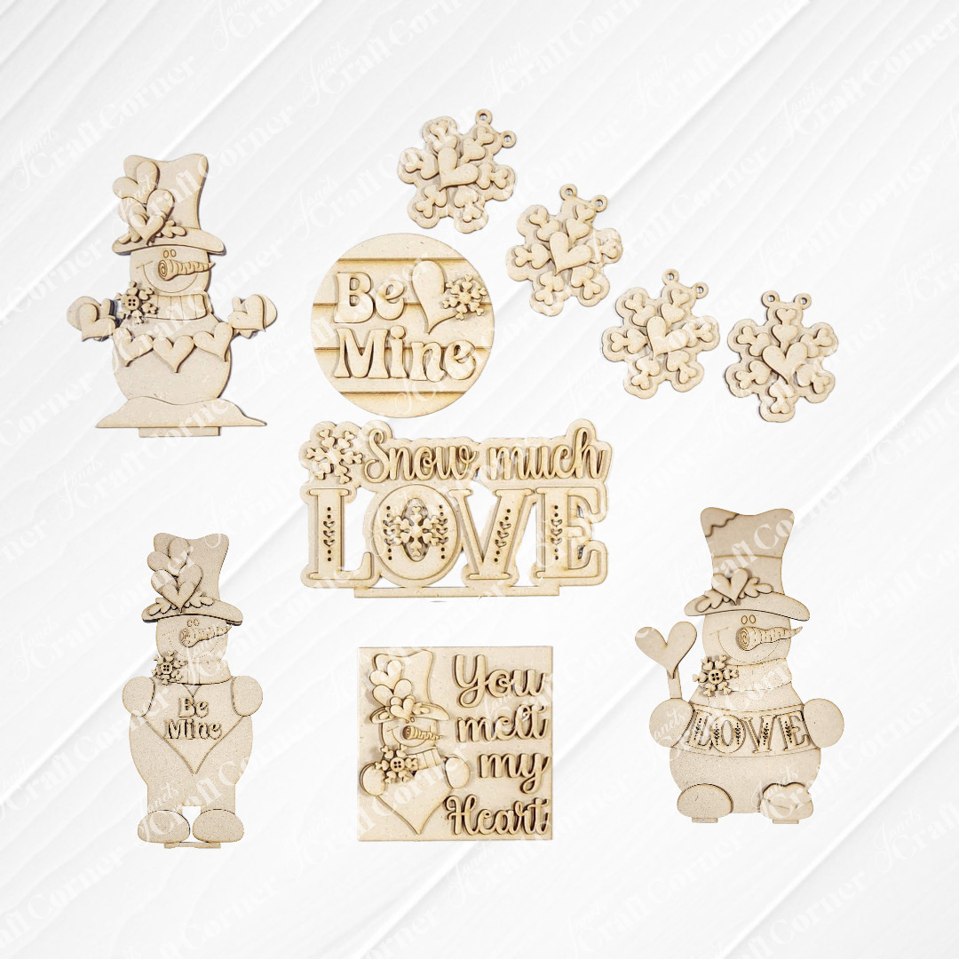 Janet's Craft Corner Valentine Snowmen Decor Set is a DIY seasonal home decor craft kit featuring wood cut-outs of snowmen, snowflakes, and sweet phrases like “Be Mine”—ideal for creative crafting or as a cute shelf sitter.