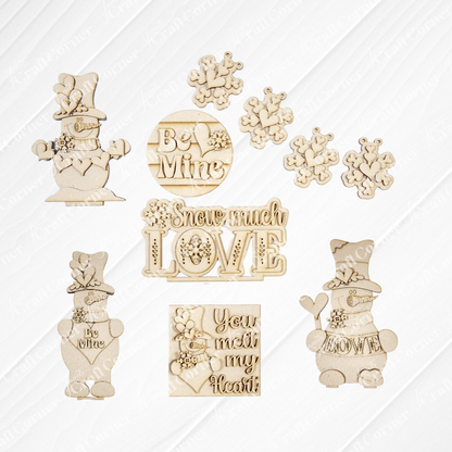 Janet's Craft Corner Valentine Snowmen Decor Set is a DIY seasonal home decor craft kit featuring wood cut-outs of snowmen, snowflakes, and sweet phrases like “Be Mine”—ideal for creative crafting or as a cute shelf sitter.