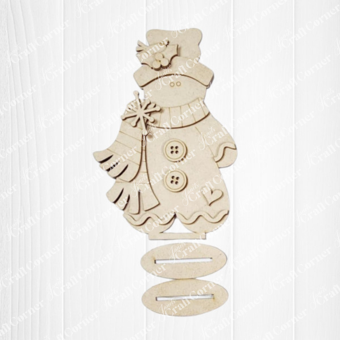 The Gingerbread Mini Shelf Sitters DIY craft kit by Janet's Craft Corner makes a charming seasonal home décor project, perfect for holiday displays on a white wooden background. Set of 1.