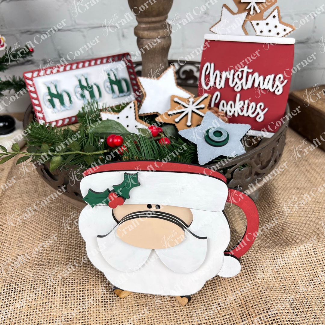 Create a festive holiday display with the Vintage Santa Cookies Decor Set DIY craft kit by Janet's Craft Corner—includes wooden Santa mug, red “Christmas Cookies” sign, star cookies, greenery, and more—ideal for tiered tray decor.
