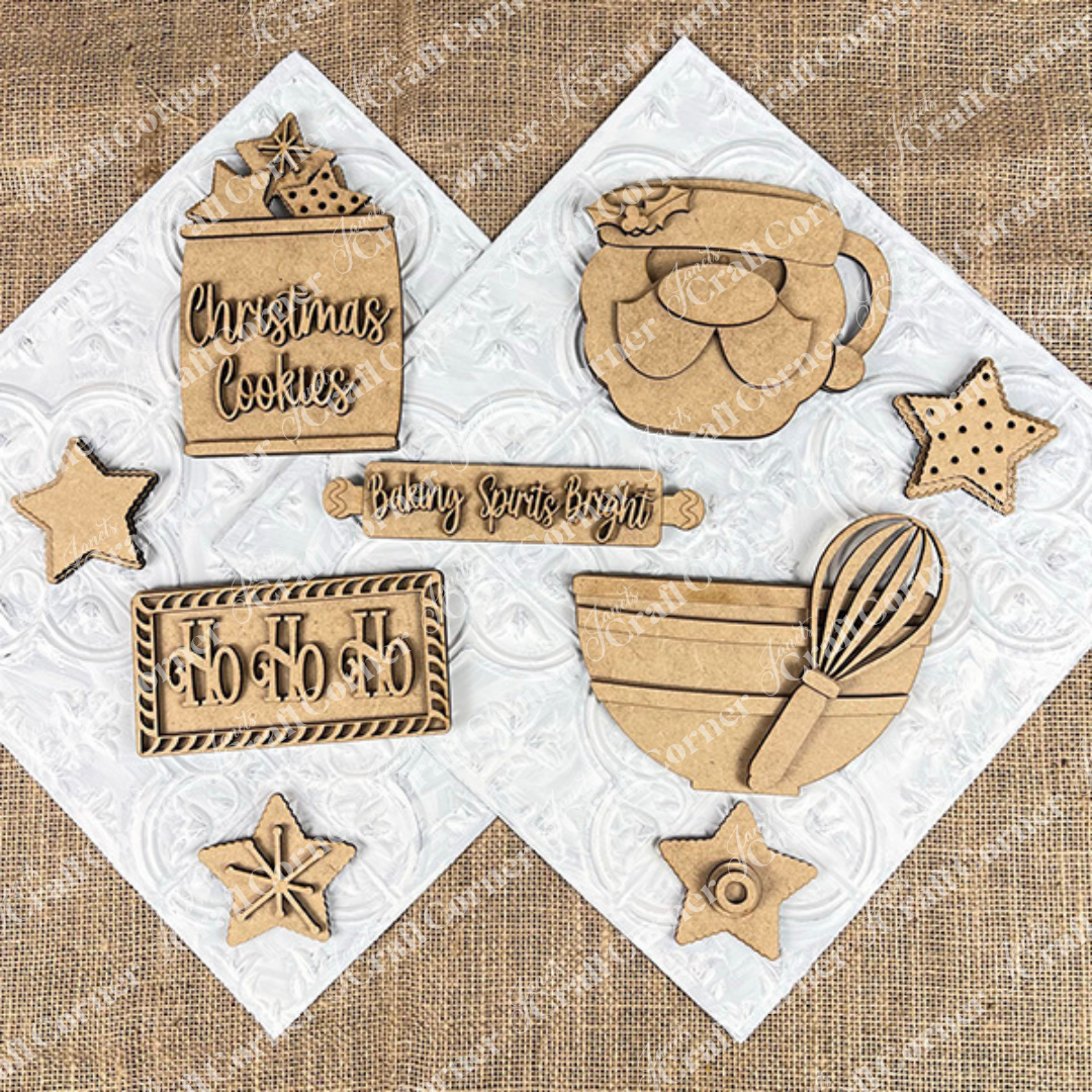 The Vintage Santa Cookies Decor Set by Janet's Craft Corner is a DIY craft kit with 6 Christmas-themed ornaments, including stars, mixing bowl, mug, "Christmas Cookies" jar, and "Ho Ho Ho" sign—perfect for festive home decor or tiered trays.