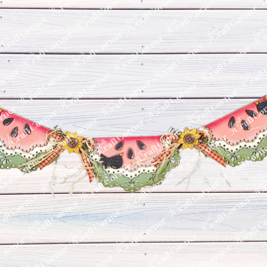 Janet’s Craft Corner 1a - MASTER product: a festive garland with watermelon slice wood cut-outs, green ruffled edges, sunflowers, buttons, and ribbon bows—ideal DIY seasonal home decor for your space.