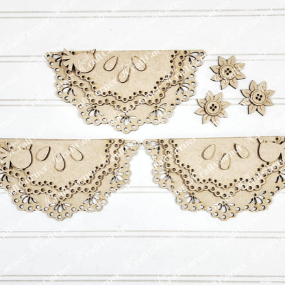 Janet's Craft Corner’s 1a - MASTER product features laser-cut wood shapes with lace-like edges—two rows of half-circles and three flowers—ideal for seasonal DIY decor, displayed on a white textured surface.