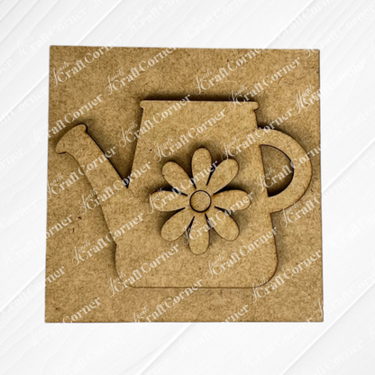 The Bloom & Grow Squares by Janet's Craft Corner is a square MDF craft piece with a watering can and flower cut-outs, ideal for Swappable Square Displays or tiered tray decor, shown on a plain background.