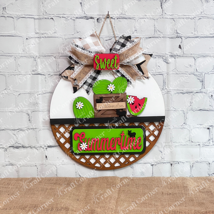 Introducing the **Summertime Watermelon Interchangeable Insert - Painted** by *Janet's Craft Corner*: This hand-painted decoration on a white door hanger base showcases watermelons and a watermelon slice, paired with a green "Summertime" sign. Enhanced with black silhouettes of ants and white daisy flowers, this charming piece is perfect for your home decor.