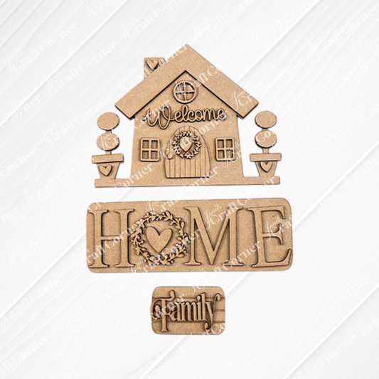 The "Welcome Home Interchangeable Insert" from Janet's Craft Corner is a DIY home decor kit that includes wooden cutouts of a house with signs reading "Welcome," "Home," and "Family." This charming piece features hand-painted details on a white textured square overlaying burlap fabric, with a heart wreath accenting the "Home" sign.