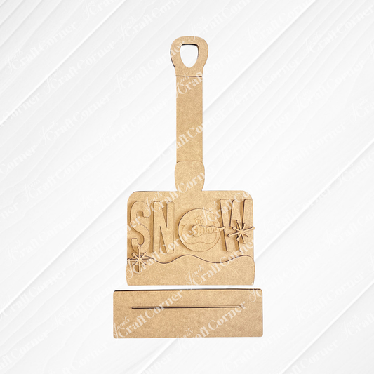 The Winter Snow Shovel Shelf Sitter DIY kit by Janet's Craft Corner features a gray shovel with “SNOW” cutouts and a snowman in the “O”—a charming winter décor piece for your home. Set of 1.