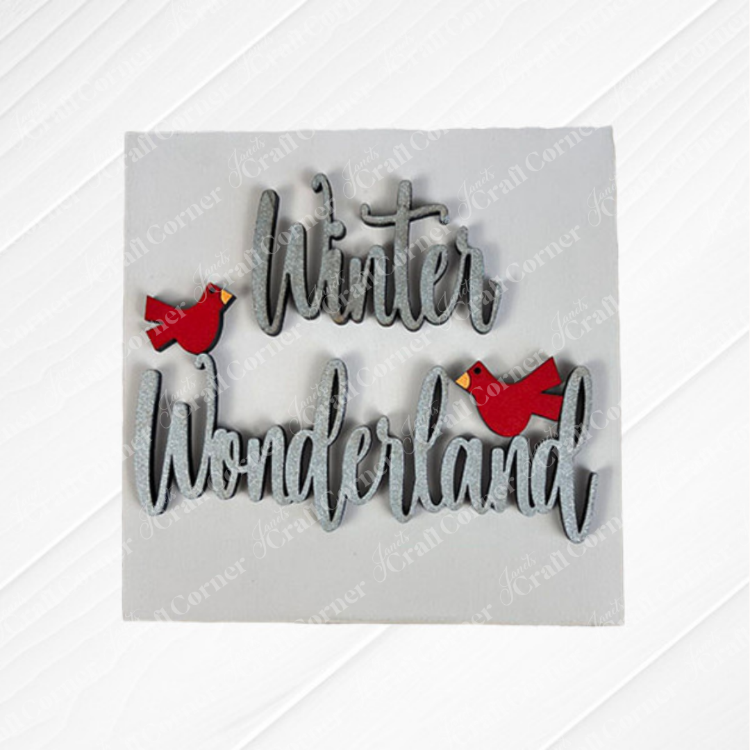 Snow Squares by Janet's Craft Corner is a square sign reading "Winter Wonderland" in cursive with two red cardinals on a white wood-textured background—a perfect seasonal DIY kit for swappable sign fans.