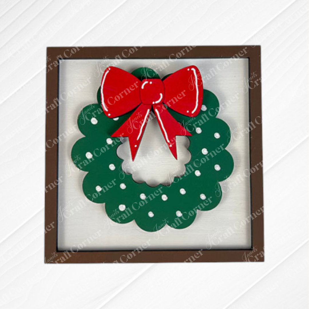 Janet's Craft Corner Merry Christmas Squares: A square wooden frame with a green wreath, white dots, and a large red bow—perfect DIY seasonal home decor or for Swappable Square Displays.