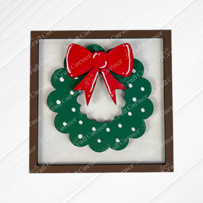 Janet's Craft Corner Merry Christmas Squares: A square wooden frame with a green wreath, white dots, and a large red bow—perfect DIY seasonal home decor or for Swappable Square Displays.