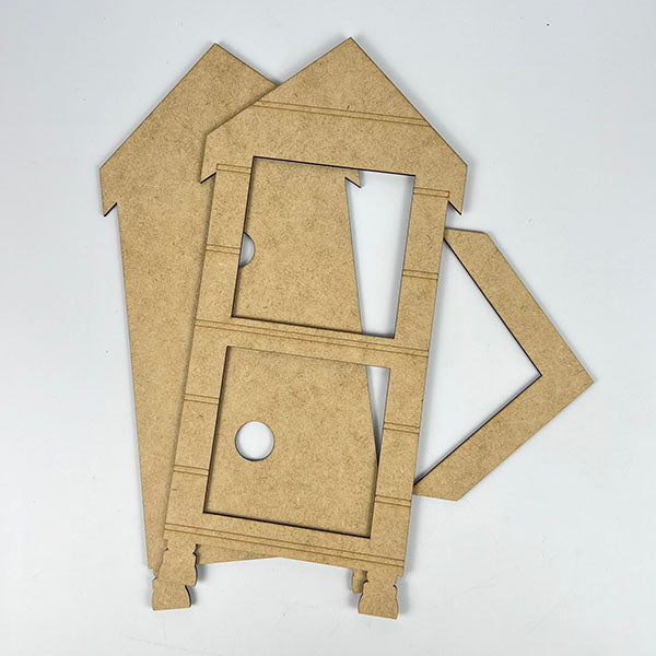 Pieces of the Janet's Craft Corner "House Interchangeable Squares Holders" seasonal craft kit are arranged on a white background. The wooden components include two wall panels with cutouts and an angled roof piece, ready for assembly. Perfect for adding a touch of farmhouse décor to your home.