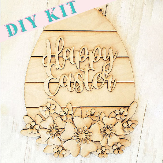 The Shiplap Egg Wall Hanger Sign from Janet's Craft Corner features a "Happy Easter" cut-out text with floral designs along the bottom. It includes a "DIY Kit" banner in the top corner and is crafted with a light wood texture backdrop, adding charm to your Easter decorations.